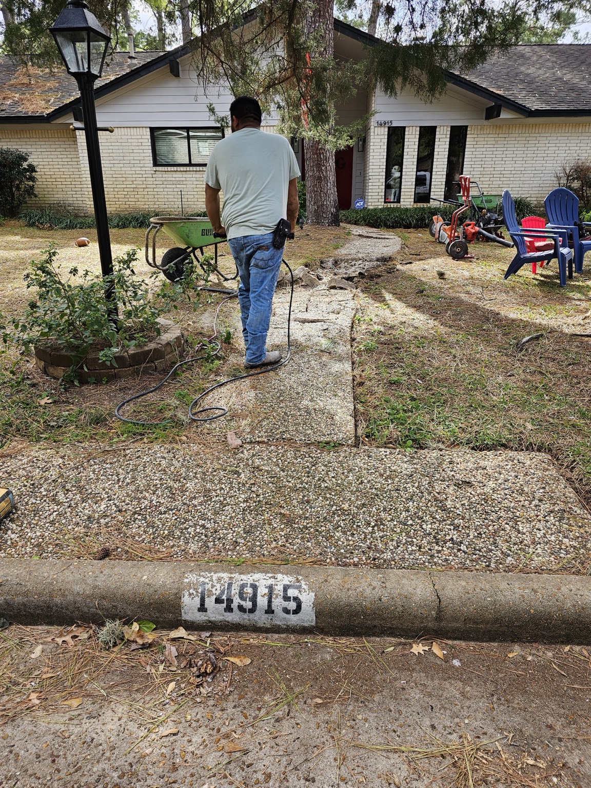 Before view of an old concrete front walkway being removed in Houston, Texas